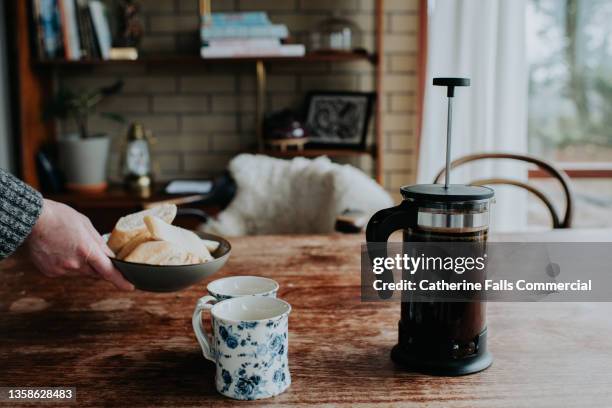 a french press coffee maker sits on a wooden table beside two mugs - decaffeinated stock pictures, royalty-free photos & images