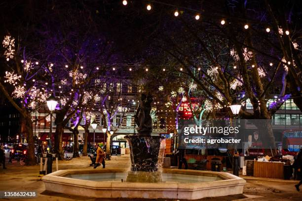 christmas decorations night lights - sloane square, london - sloane square stock pictures, royalty-free photos & images