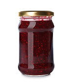 Glass jar with raspberry jam isolated on white. Pickling and preservation