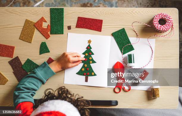 little kid crafting christmas tree from paper. - christmas cards stock pictures, royalty-free photos & images