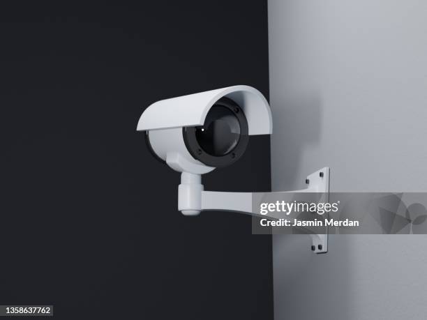 surveillance camera on the wall - looking around on white background stock pictures, royalty-free photos & images