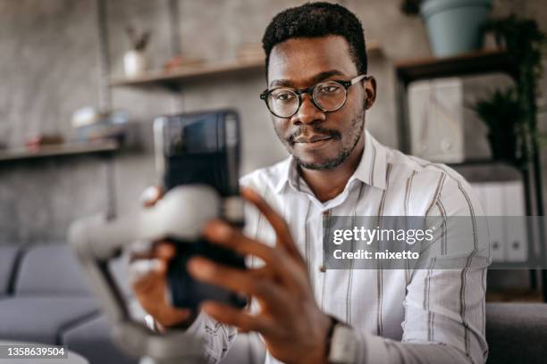 man preparing smart phone for recording vlog - work video call stock pictures, royalty-free photos & images