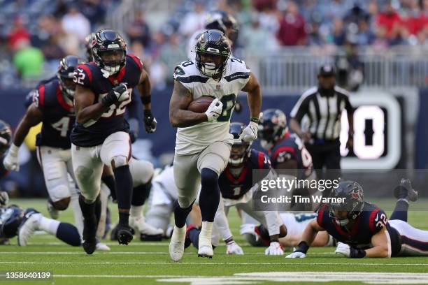 Rashaad Penny of the Seattle Seahawks runs the ball for a touchdown during the fourth quarter against the Houston Texans at NRG Stadium on December...