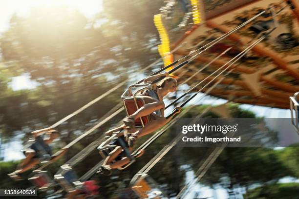 teenage girl enjoying chair swing ride - swing carousel stock pictures, royalty-free photos & images