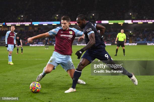 Michail Antonio of West Ham is tackled by James Tarkowski of Burnle during the Premier League match between Burnley and West Ham United at Turf Moor...