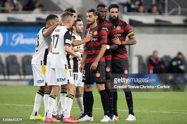 John Koutroumbis , Bernie Ibini-Isei and Rhys Williams of the Wanderers in attacking formation before a corner during the A-League Mens match between...
