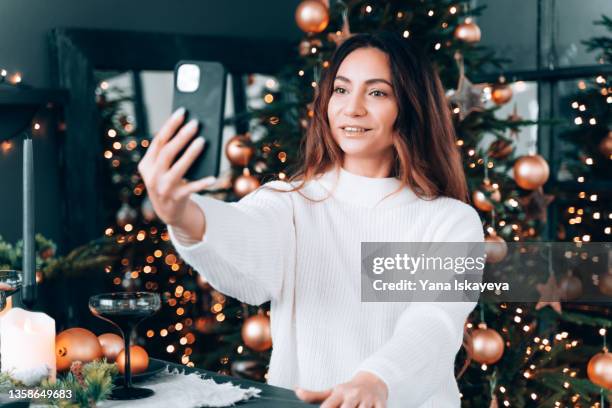 beautiful woman blogger is recording a holiday video stream for her social media followers - social content stock pictures, royalty-free photos & images