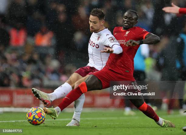 Matthew Cash of Aston Villa battles for possession with Sadio Mane of Liverpool during the Premier League match between Liverpool and Aston Villa at...