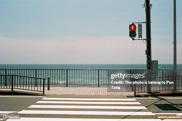 signal sign on road against sea - kamakura stock photos et images de collection