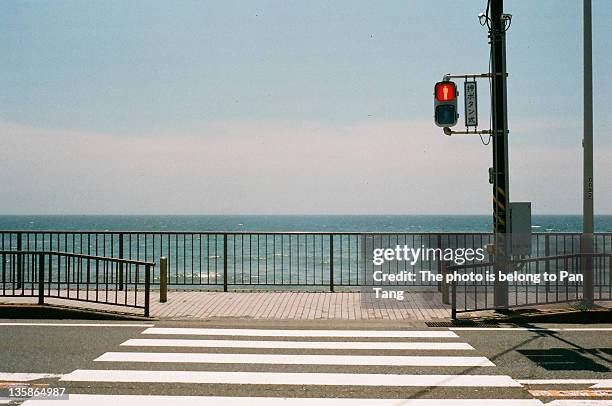 signal sign on road against sea - kamakura city stock pictures, royalty-free photos & images