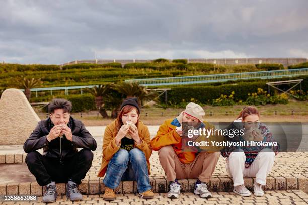 people eating light meals for lunch at outdoor - adults eating hamburgers foto e immagini stock
