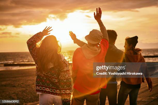 silhouette of coastal dance team - asian group holiday stock pictures, royalty-free photos & images