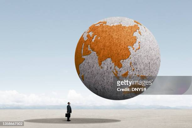 man stands in the shadow of asia - world economy stock pictures, royalty-free photos & images