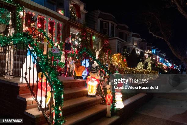 Row of homes are covered in Christmas lights at the Dyker Heights Christmas Lights on December 12, 2021 in the Brooklyn Borough of New York City. The...