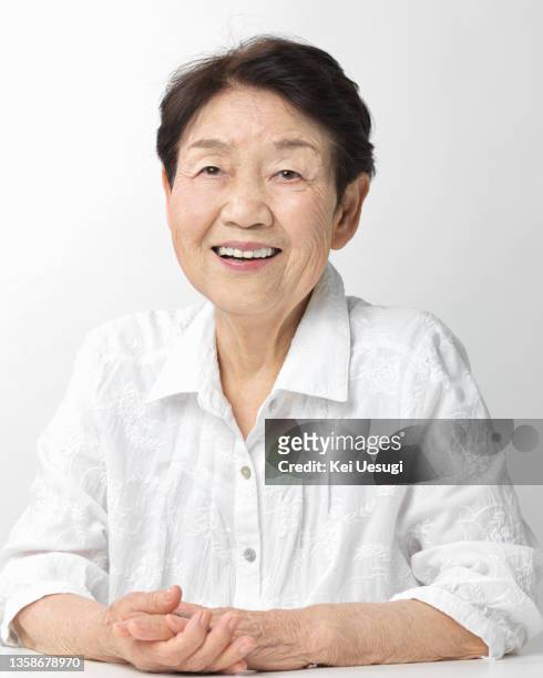 portrait of a smiling old woman - japanese old woman stock pictures, royalty-free photos & images