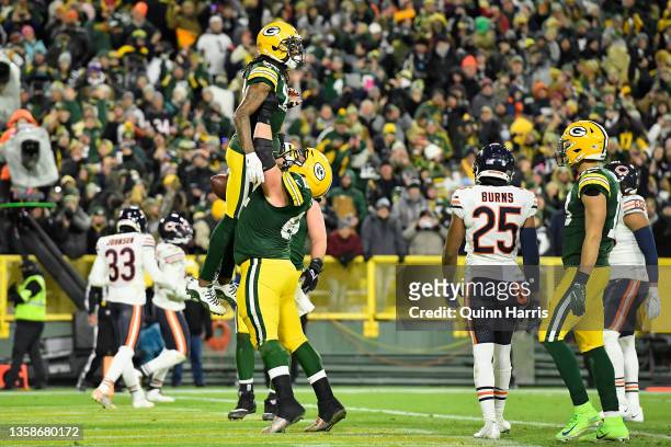 Davante Adams of the Green Bay Packers is lifted by Abdullah Anderson after a three-yard touchdown reception against the Chicago Bears during the...