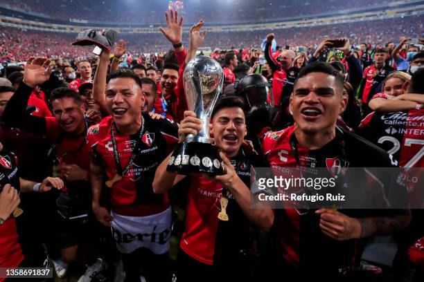 Aldo Rocha of Atlas holds the trophy and celebrates with teammates after winning the final second leg match between Atlas and Leon as part of the...