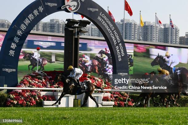 Jockeys on their horses rush towards the finish line during the 2021 Longines Hong Kong International Races at Sha Tin Racecourse on December 12,...