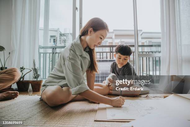 thai woman with her child drawing picture as a weekend activity-stock photo - family rabbit stock pictures, royalty-free photos & images