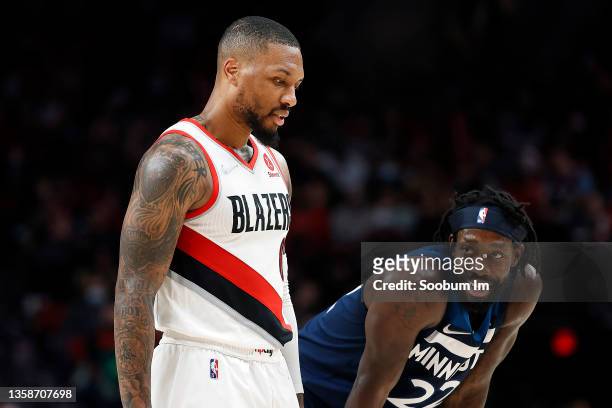 Patrick Beverley of the Minnesota Timberwolves looks at Damian Lillard of the Portland Trail Blazers during the second half at Moda Center on...