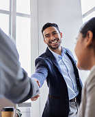 Shot of two business people shaking hands during a meeting