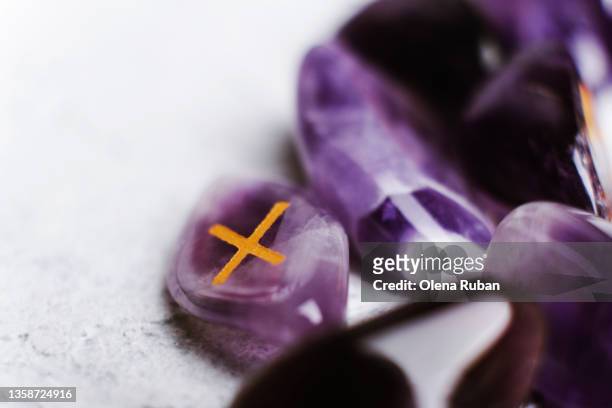 purple divination stone runes. - rune symbols stock pictures, royalty-free photos & images