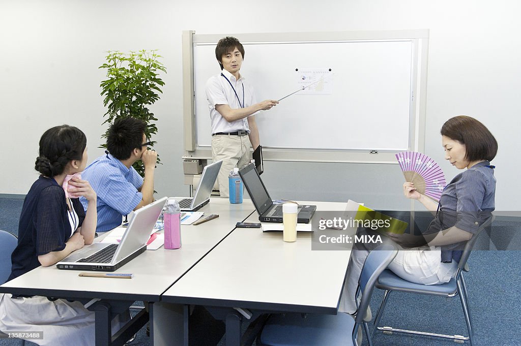 Businessmen and businesswomen in business casual having meeting