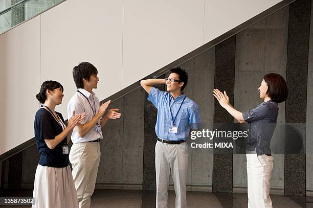 businessman in business casual praised at lobby of building - businessman applauding stock pictures, royalty-free photos & images