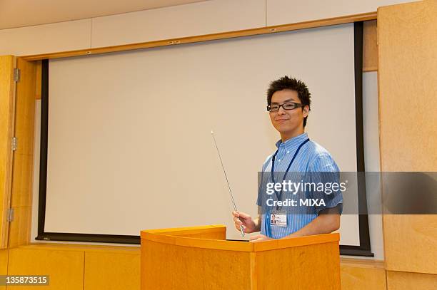 businessman in business casual making a presentation - pointer stick stock pictures, royalty-free photos & images