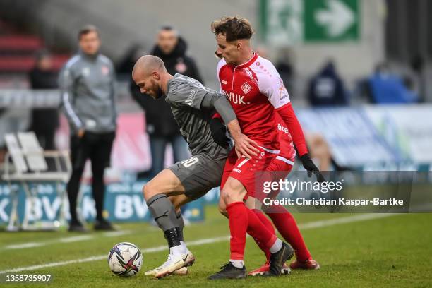 Manfred Starke of FSV Zwickau is tackled by Leon Schneider of FC Wuerzburger Kickers and Mirnes Pepic of FC Wuerzburger Kickers during the 3. Liga...