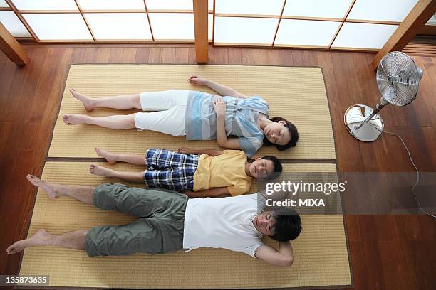 family napping on tatami mat - short sleeved fotografías e imágenes de stock
