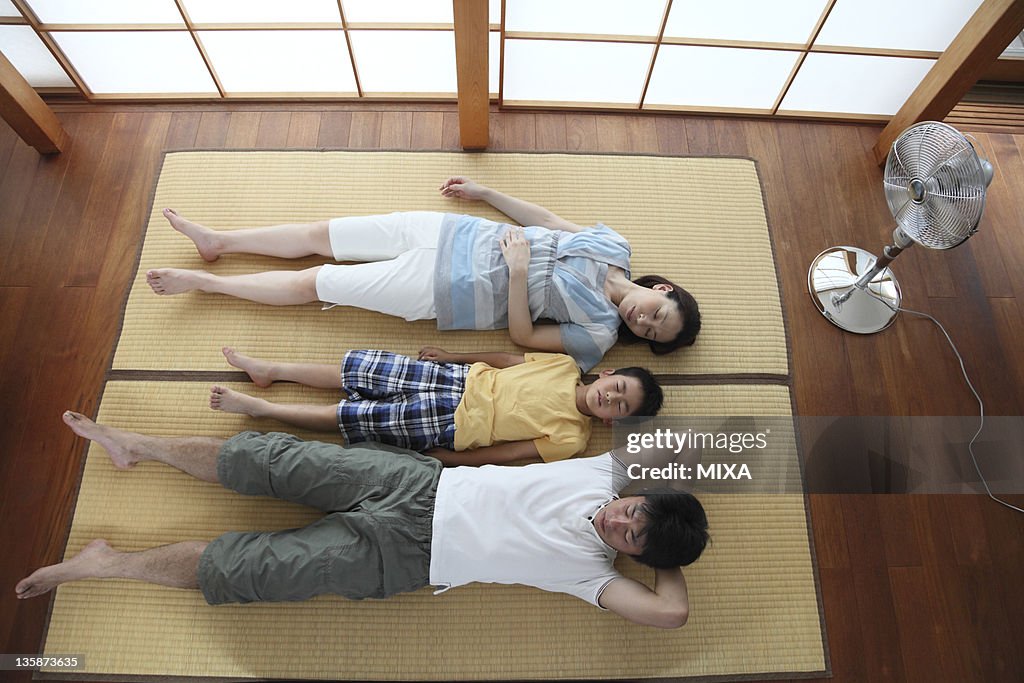 Family napping on tatami mat
