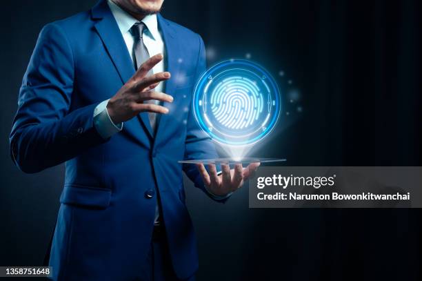 the businessman playing metaverse via futuristic tablet and touching on fingerprint hologram - smartphone hologram stock pictures, royalty-free photos & images