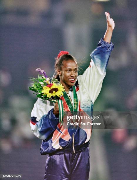 Bronze medallist Jackie Joyner-Kersee of the United States stands on the podium following the Women's Long Jump competition on 2nd August 1996 during...