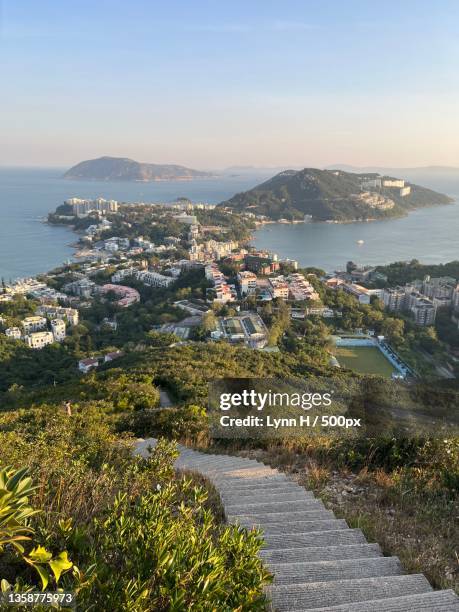 tai tam country park,scenic view of sea by buildings against sky,hong kong - tai tam country park stock pictures, royalty-free photos & images