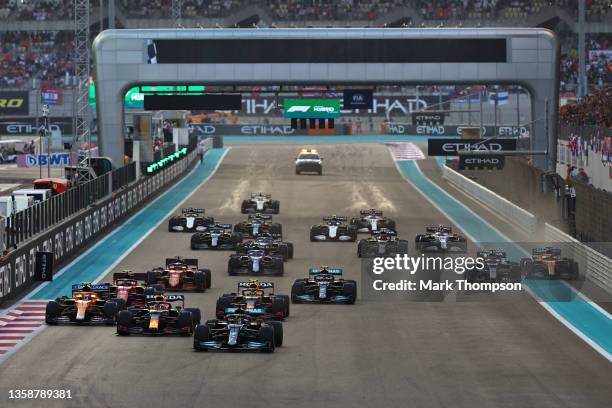 Lewis Hamilton of Great Britain driving the Mercedes AMG Petronas F1 Team Mercedes W12 leads the field into turn one at the start during the F1 Grand...