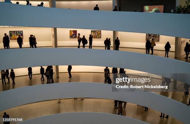 Museum goers look at paintings by Russian artist Vasily Kandinsky December 12, 2021 at the Guggenheim Museum in New York City. Kandinsky is...