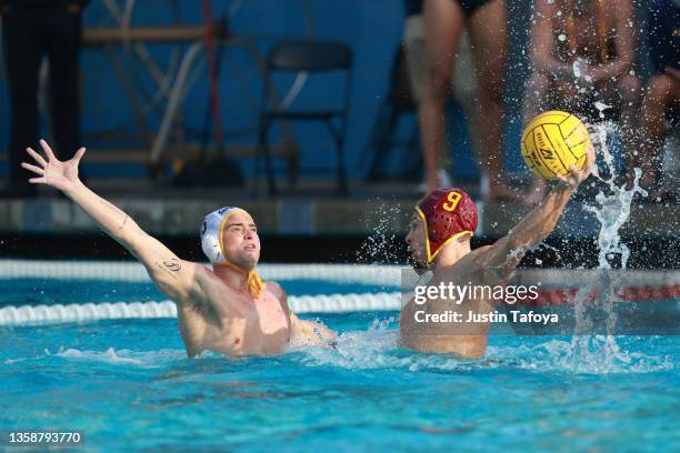 Jacob Mercep of the USC Trojans is defended by Jake Stone of the California Golden Bears during the Division I Men's Water Polo Championship held at...