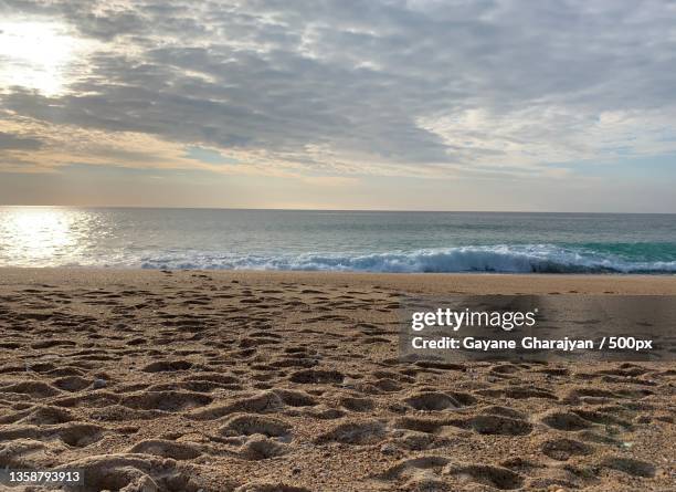 captivating nazare beach,scenic view of beach against sky during sunset,nazare,portugal - gayane stock pictures, royalty-free photos & images