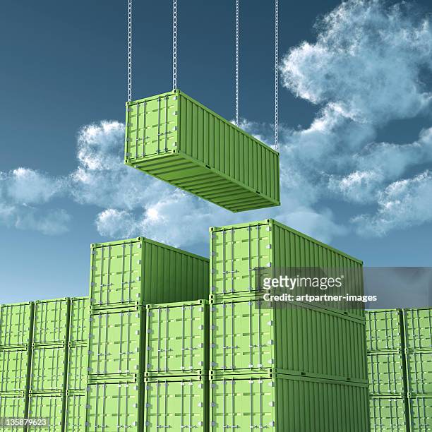 unloading green cargo container - stacking stock-fotos und bilder