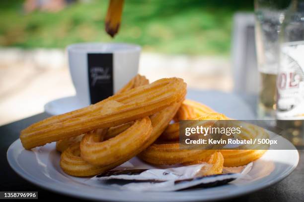 chocolate con churros,close-up of cookies in plate on table - churro stockfoto's en -beelden