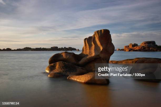 granit,scenic view of rocks on beach against sky,france - boulder stock pictures, royalty-free photos & images