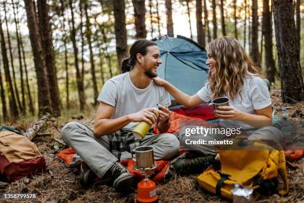 young couple making coffee during hiking - camping friends stock pictures, royalty-free photos & images