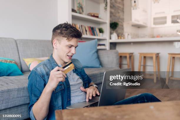 young man buying something online from home - teenager boy shopping stock pictures, royalty-free photos & images