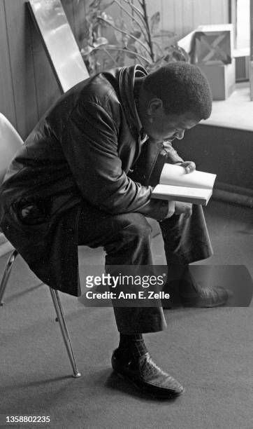 An unidentified man reads a book at the Art & Soul community art center , in the Lawndale neighborhood, Chicago, Illinois, December 1968 or early...