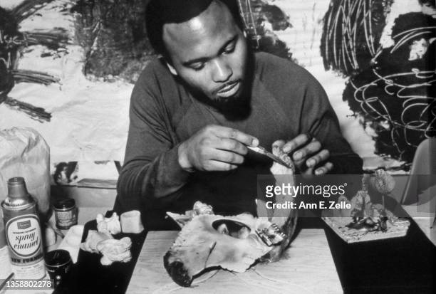 View of artist Peter Gilbert as he works on a bone sculpture at the Art & Soul community art center , in the Lawndale neighborhood, Chicago,...