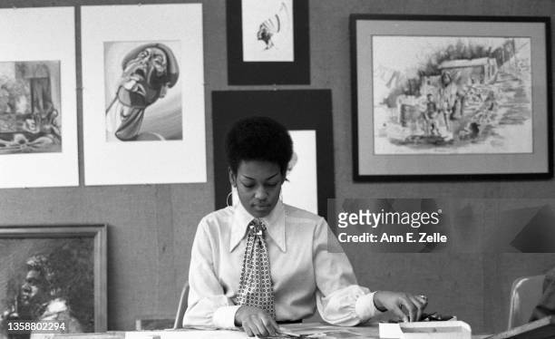 View of an unidentified member of the Conservative Vice Lords as she works in an office the Art & Soul community art center , in the Lawndale...