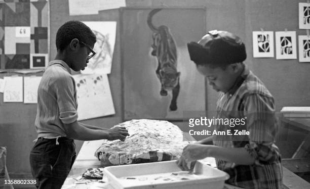 Two students, one named William 'Sonny' Fletcher , make a papier-mache mask in a class at the Art & Soul community art center , in the Lawndale...