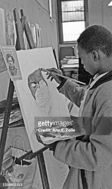 Teenaged artist paints a portrait at the Art & Soul community art center , in the Lawndale neighborhood, Chicago, Illinois, December 1968 or early...