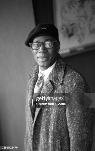 Portrait of an unidentified man, in a beret and overcoat, as he attends the opening event for the Art Contest Exhibition at the Art & Soul community...